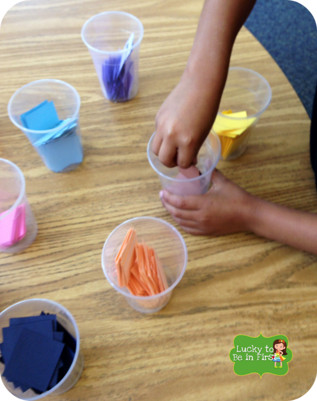 cutting up square colored paper for a fraction art activity | Lucky Learning with Molly Lynch