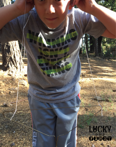 a 1st grader doing a sound activity with a clothes hanger | Lucky Learning with Molly Lynch 