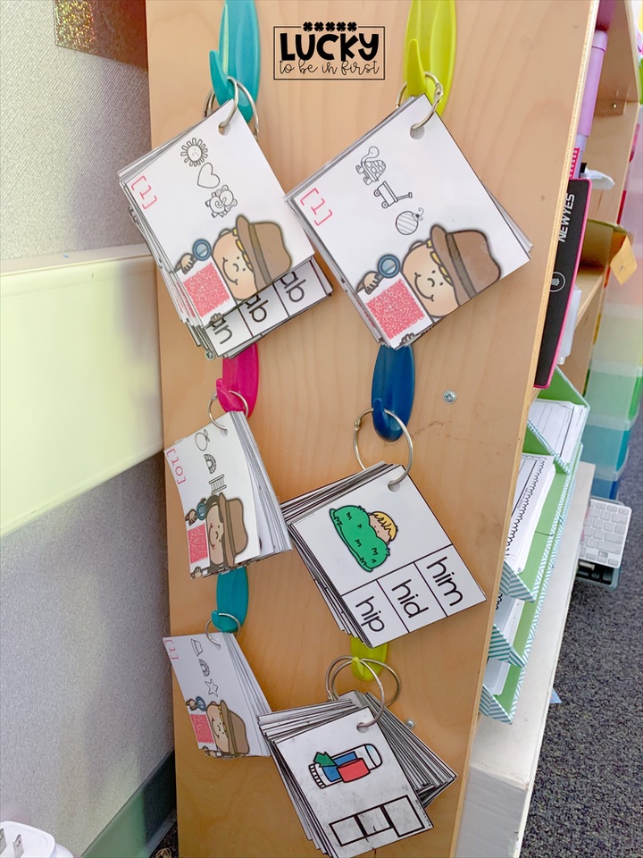 teacher hanging word work activities on command hooks in her 1st grade classroom | Lucky Learning with Molly Lynch 