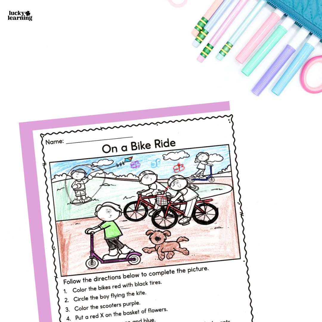 A completed children's worksheet titled "On a Bike Ride" with a colored drawing of kids biking and scootering, a dog, and instructions at the bottom for following directions. Colored pens are nearby.