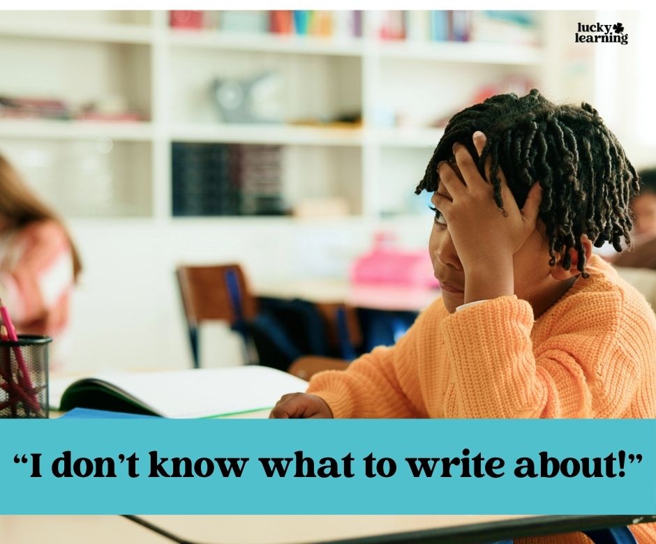 A child sits at a desk with a book open, resting their head on one hand and looking frustrated. Text reads: “I don’t know what to write about!”—the perfect moment to introduce journal writing prompts for first grade.