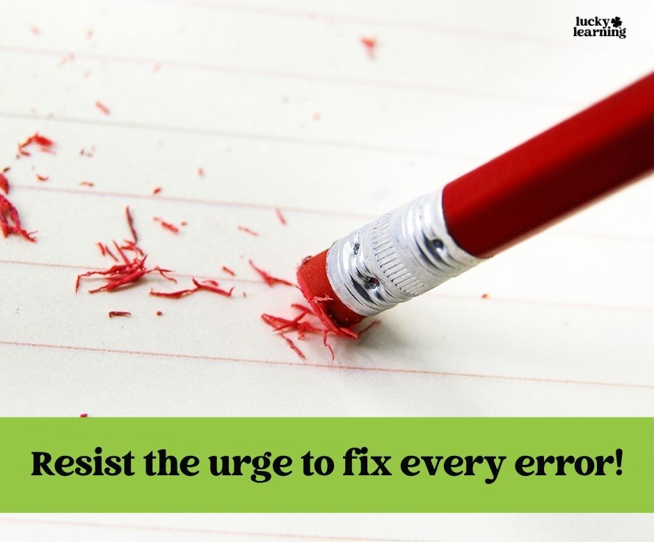 A close-up of a pencil eraser rubbing out writing on lined paper with eraser shavings, and text saying, “Resist the urge to fix every error!”—perfect advice when using journal writing prompts for first grade.