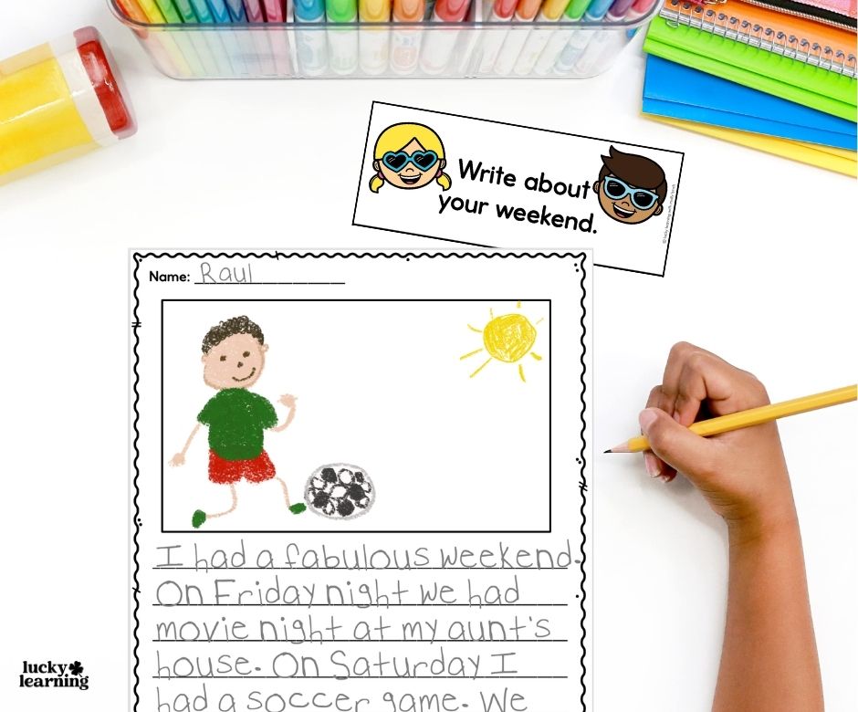 A child writes and draws about their weekend, describing a movie night and a soccer game; colored pencils and markers are visible at the top, making it a fun example of journal writing prompts for first grade.