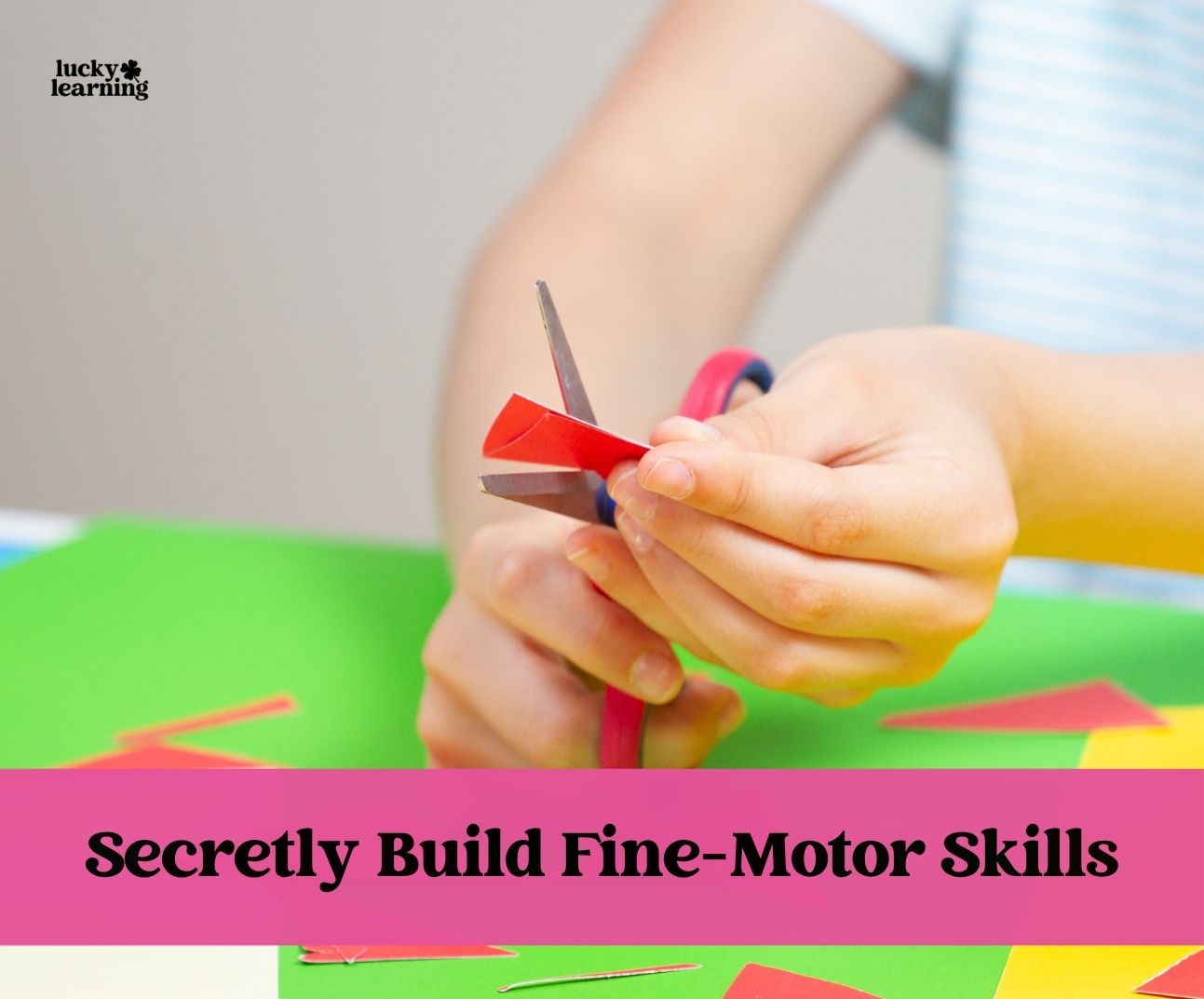 Child cutting red paper with scissors on a green surface, promoting fine-motor skills development—just like pattern block activities; text overlay reads, "Secretly Build Fine-Motor Skills.