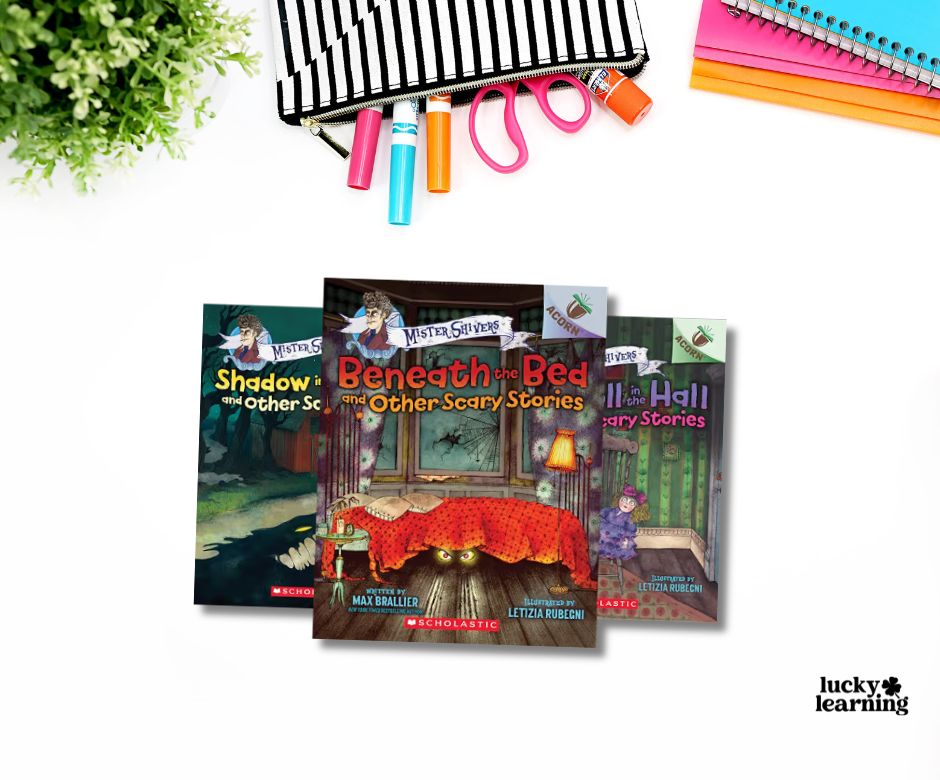 Three children’s scary story books from the popular book series overlap on a white desk, surrounded by colorful school supplies and a green plant in the corner. The books are from the Mister Shivers series by Max Brallier.